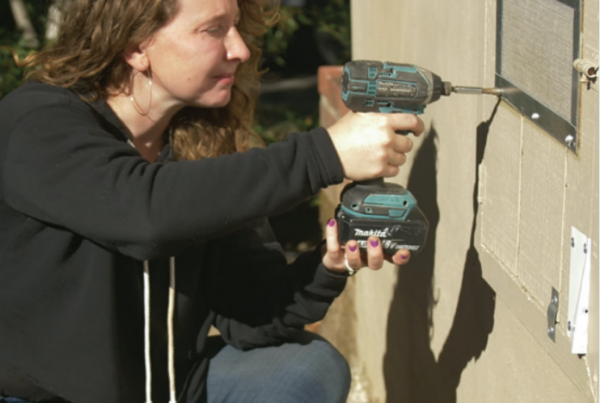 woman installing vent